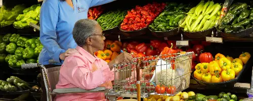 Old lady on a wheelchair doing grocery